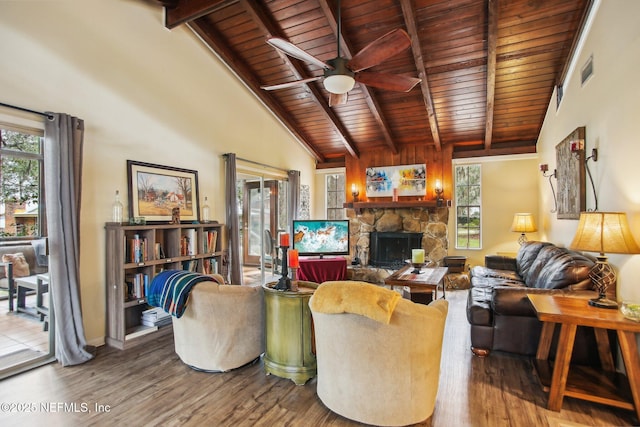 living room featuring hardwood / wood-style flooring, ceiling fan, beam ceiling, a fireplace, and wooden ceiling