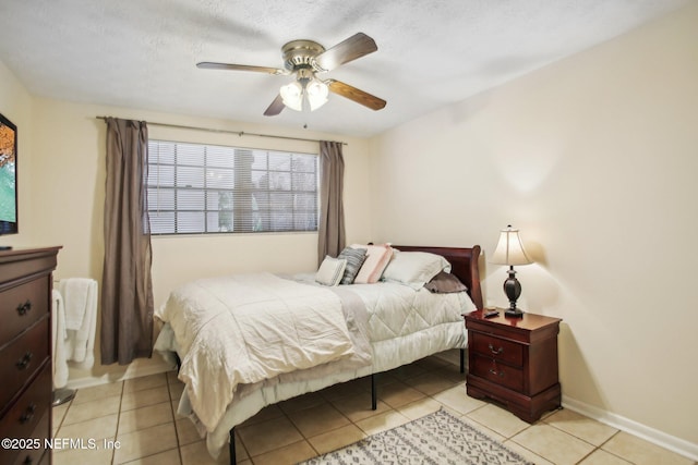 bedroom with light tile patterned floors, a textured ceiling, and ceiling fan
