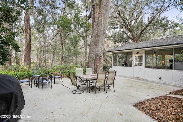 view of patio / terrace with a grill and a sunroom