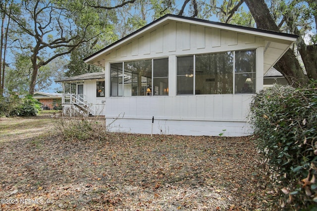 view of side of home with a sunroom