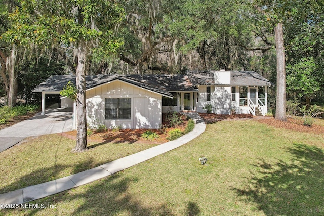 ranch-style home with a carport and a front yard