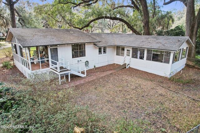back of house with a sunroom