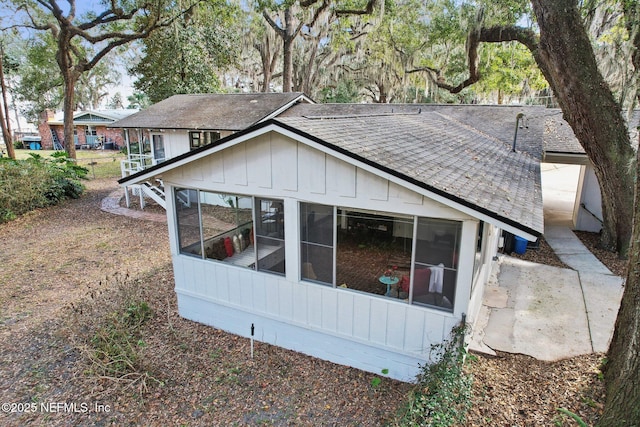 rear view of house featuring a sunroom