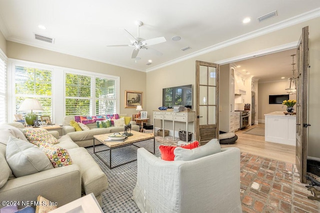 living room with crown molding and ceiling fan