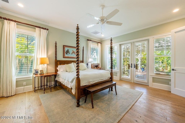 bedroom featuring multiple windows, ornamental molding, access to exterior, and light hardwood / wood-style floors