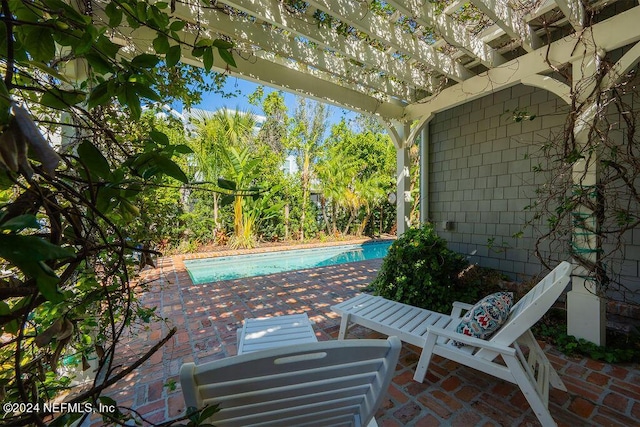 view of pool with a pergola and a patio area