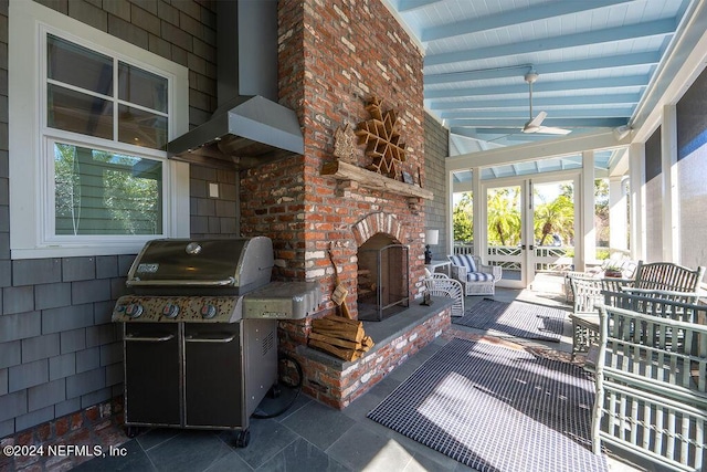 view of patio / terrace with a grill and a fireplace