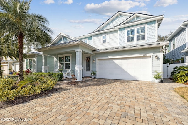 view of front facade with a garage and a porch