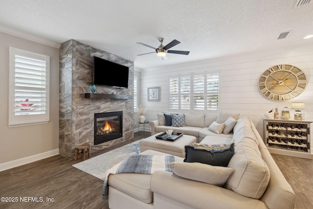 living room featuring a wealth of natural light, dark wood-type flooring, and a textured ceiling