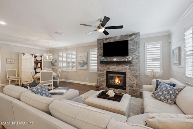 living room with crown molding, a fireplace, and a textured ceiling