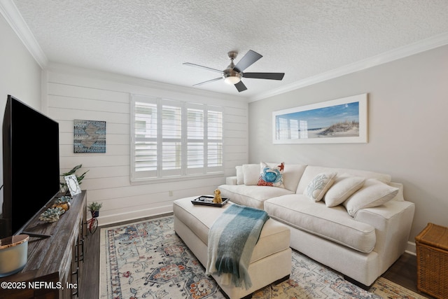 living room with ornamental molding, hardwood / wood-style floors, and ceiling fan