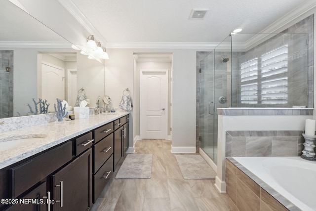 bathroom with ornamental molding, independent shower and bath, and vanity