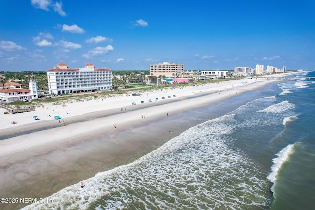 drone / aerial view with a beach view and a water view