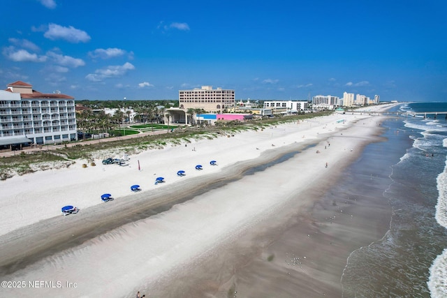 bird's eye view featuring a water view and a beach view