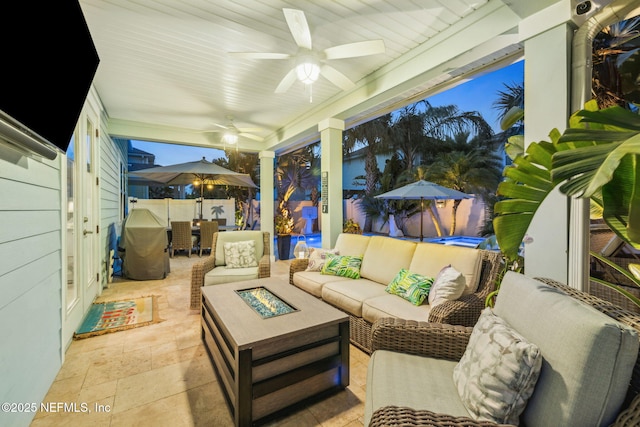 view of patio / terrace featuring an outdoor living space with a fire pit, a ceiling fan, and outdoor dining area