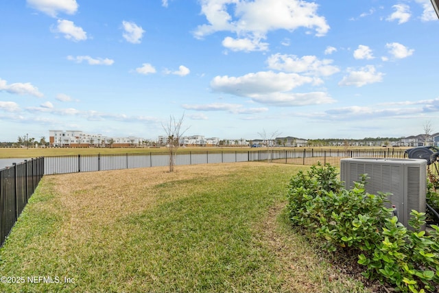 view of yard featuring a fenced backyard and central AC unit