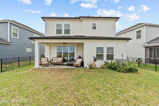 back of property with a fenced backyard, a yard, and an outdoor hangout area