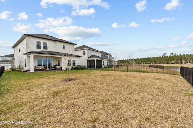 rear view of house featuring a fenced backyard and a yard