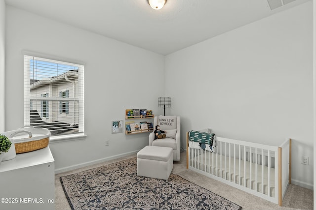 carpeted bedroom with visible vents, a crib, and baseboards