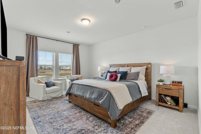 carpeted bedroom with baseboards and visible vents