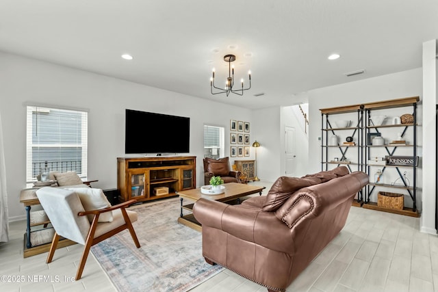 living room with wood tiled floor, recessed lighting, visible vents, and an inviting chandelier