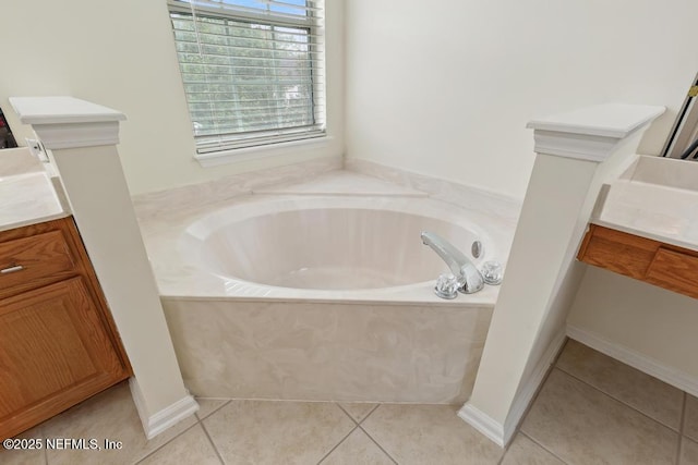 bathroom featuring tile patterned flooring, vanity, and a relaxing tiled tub