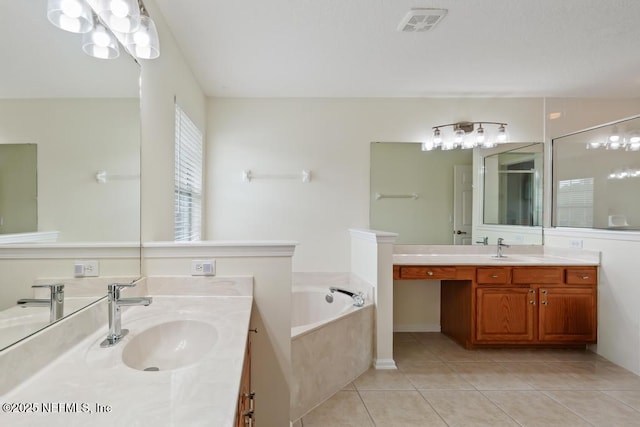 bathroom featuring vanity, a tub to relax in, and tile patterned floors