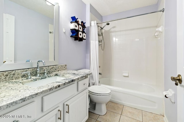 full bathroom featuring tile patterned flooring, shower / tub combo, vanity, a textured ceiling, and toilet