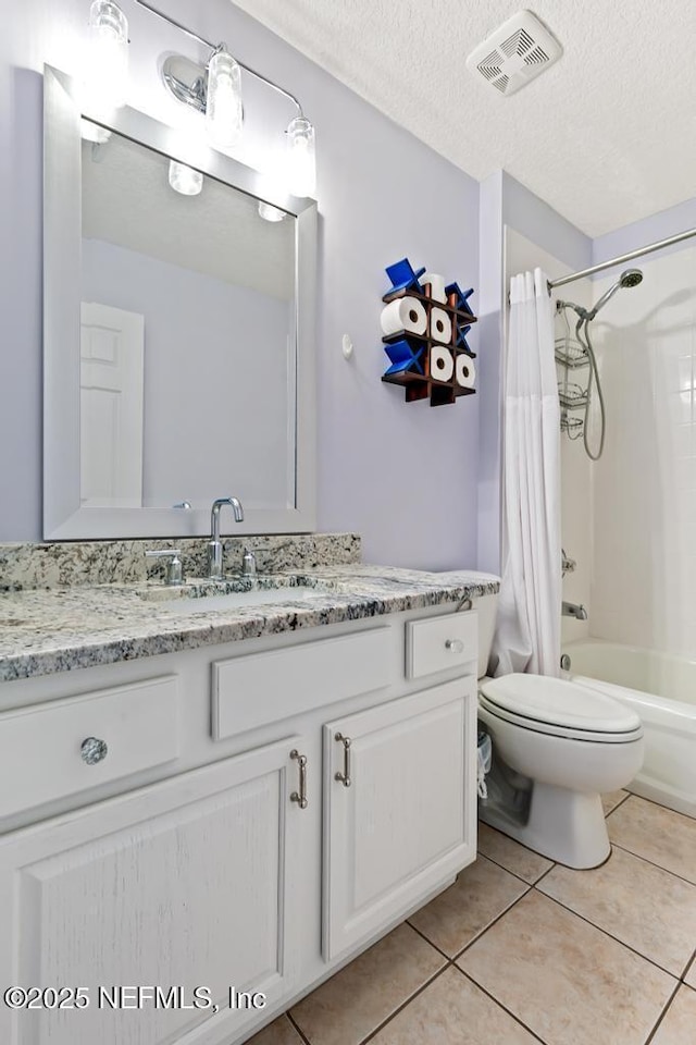 full bathroom featuring tile patterned floors, toilet, a textured ceiling, vanity, and shower / bath combo with shower curtain