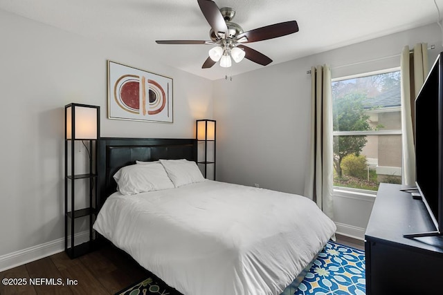 bedroom with dark hardwood / wood-style floors and ceiling fan