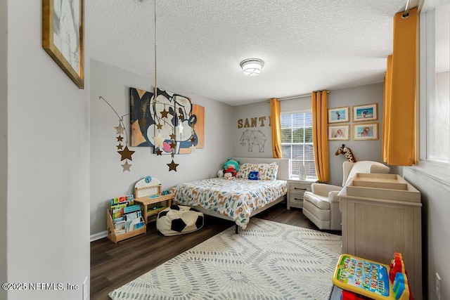 bedroom featuring dark wood-type flooring and a textured ceiling