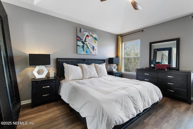 bedroom featuring lofted ceiling, dark hardwood / wood-style floors, and ceiling fan