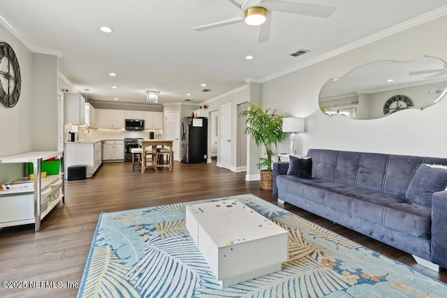 living room featuring ornamental molding, ceiling fan, and dark hardwood / wood-style flooring