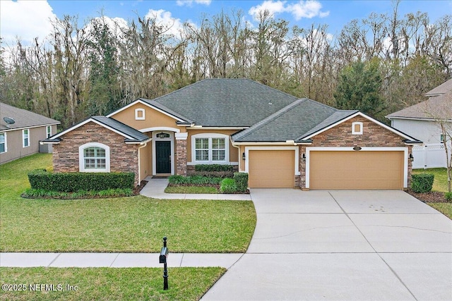 view of front of home featuring a garage and a front lawn