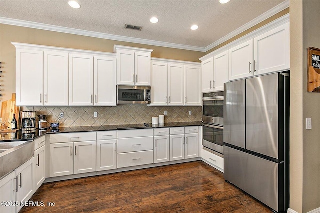 721 W Kings College Dr, Saint Johns, FL 32259 - kitchen featuring crown molding, appliances with stainless steel finishes, dark wood-type flooring, and white cabinets