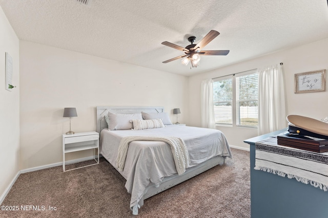 bedroom featuring ceiling fan, a textured ceiling, and dark colored carpet