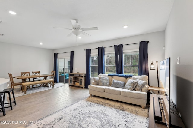 living area with ceiling fan, wood finished floors, and recessed lighting