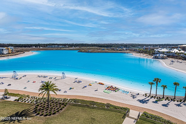 bird's eye view featuring a water view and a view of the beach