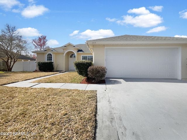 ranch-style home with a garage and a front yard