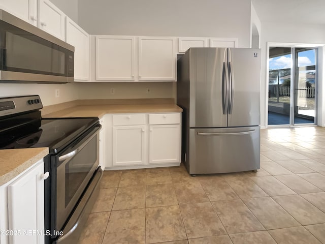 kitchen featuring white cabinetry, light tile patterned floors, and appliances with stainless steel finishes