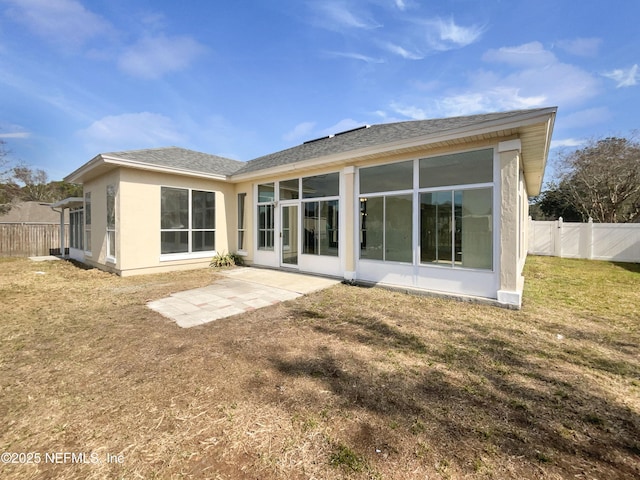 rear view of property featuring a yard and a patio