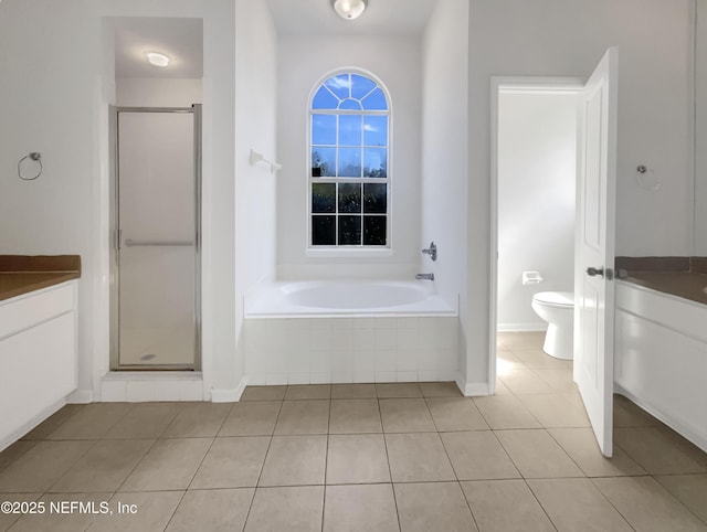 full bathroom with tile patterned flooring, vanity, plus walk in shower, and toilet