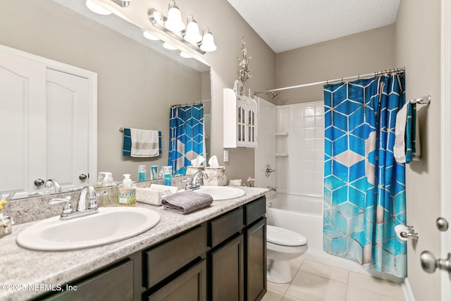 full bathroom featuring a textured ceiling, tile patterned flooring, a sink, and shower / bath combo with shower curtain