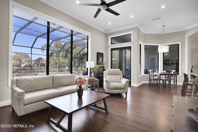 living room featuring ceiling fan, ornamental molding, and dark hardwood / wood-style floors