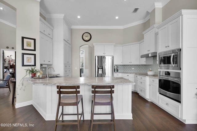 kitchen with white cabinetry, appliances with stainless steel finishes, kitchen peninsula, and sink