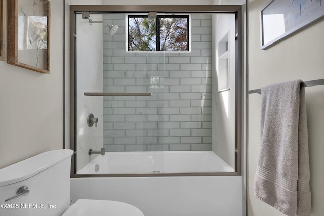 bathroom with bath / shower combo with glass door and toilet