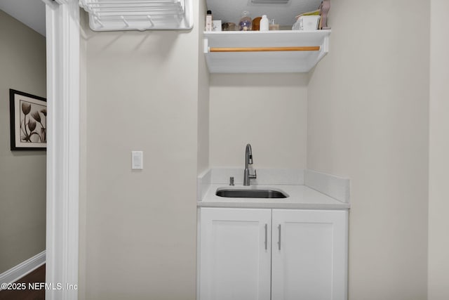 interior space with sink and white cabinets