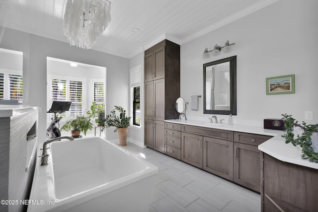 bathroom featuring ornamental molding, a bathtub, and vanity