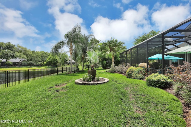 view of yard with glass enclosure