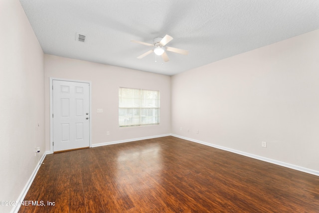 unfurnished room featuring a textured ceiling, dark hardwood / wood-style floors, and ceiling fan